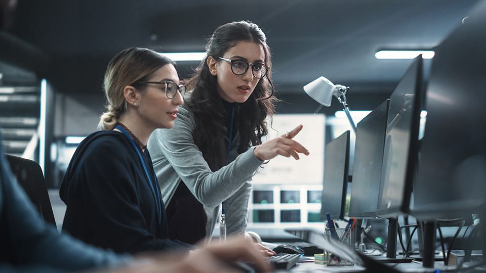 Two students working on a cybersecurity class