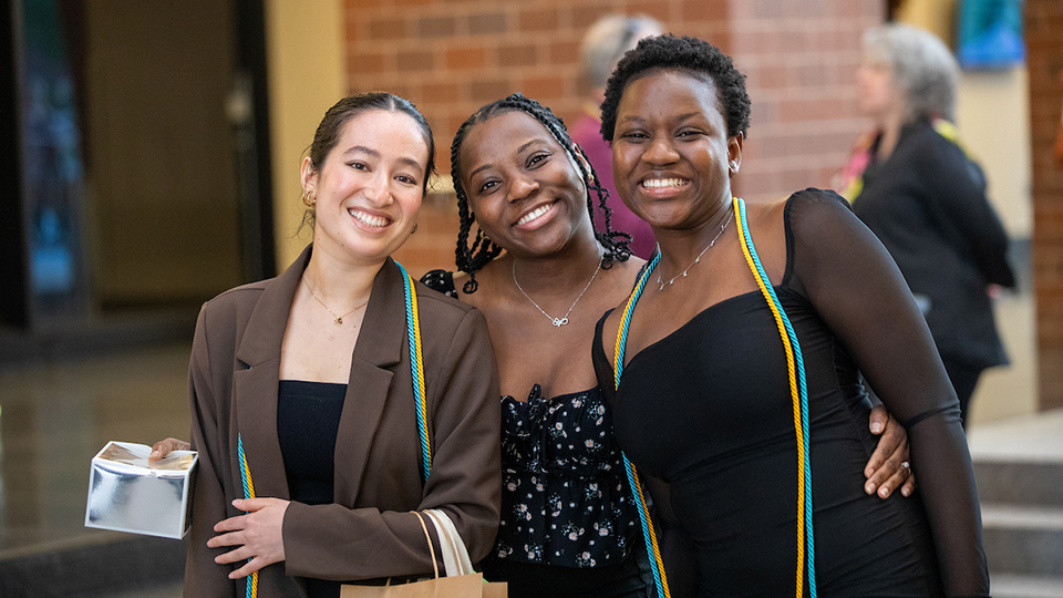 Group of 3 students grinning at the camera