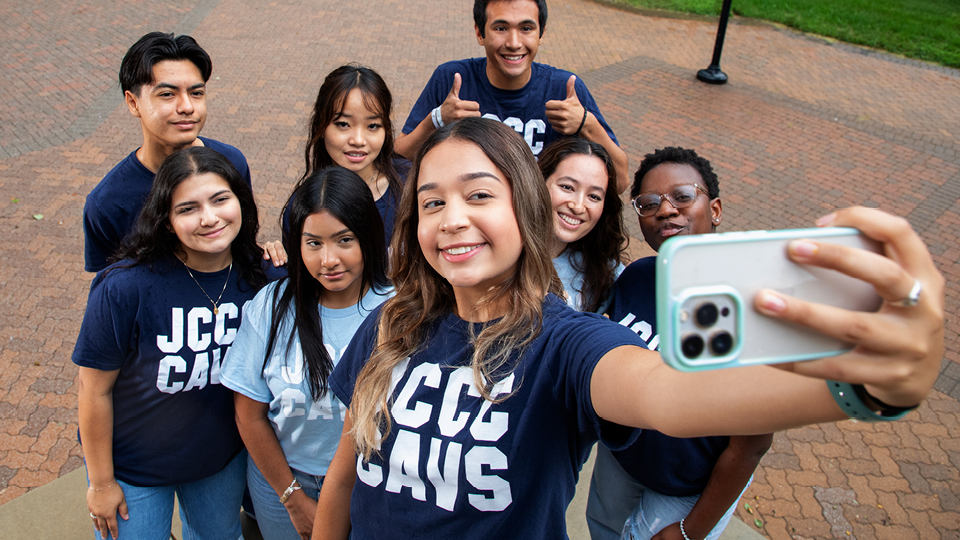 a group of students wearing JCCC t-shirts taking a selfie