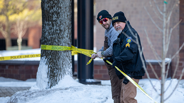 Two JCCC police officers putting up crime scene tape